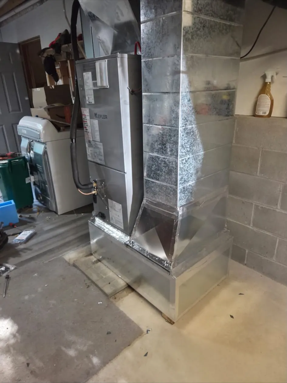 New air handler and sheet metal ductwork in a basement