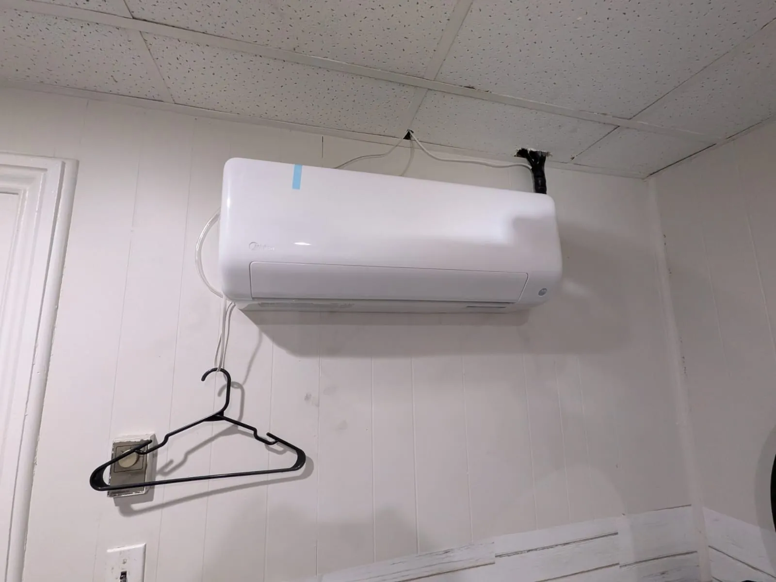 Ductless wall unit in a bright laundry room