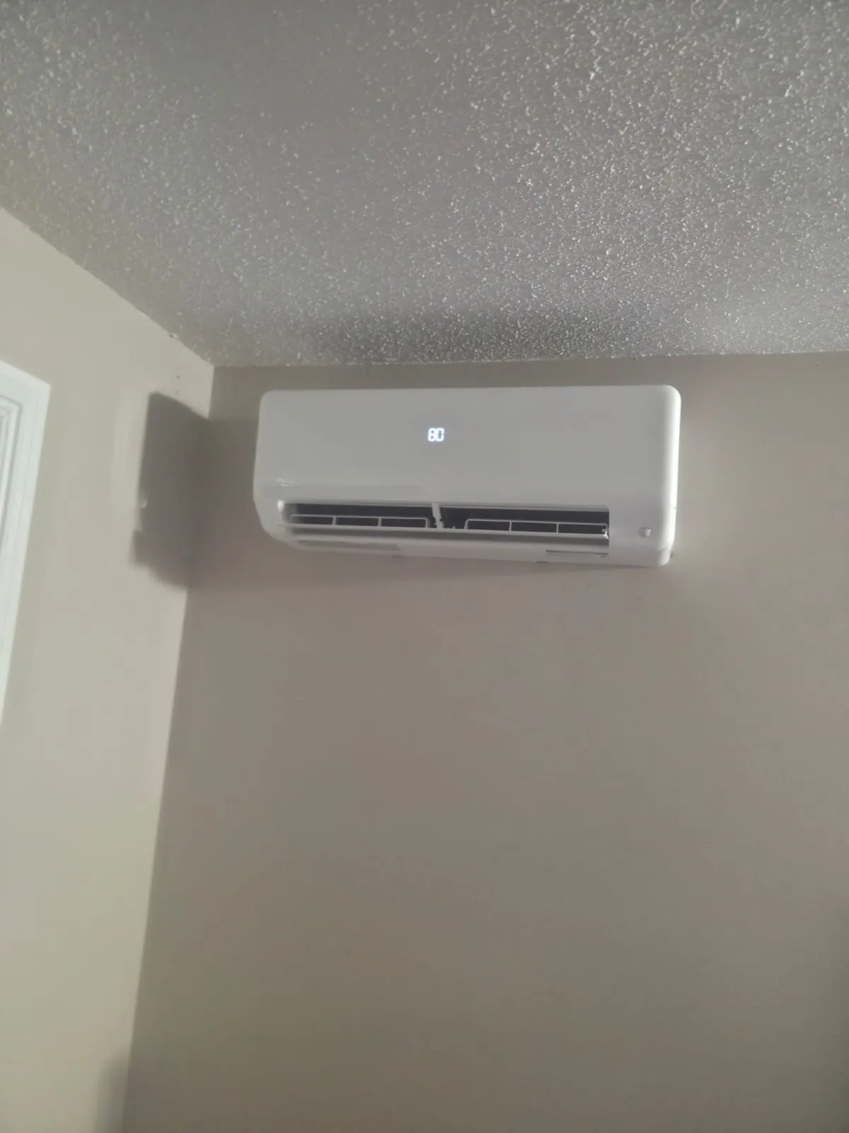 Ductless wall unit high on a living room wall