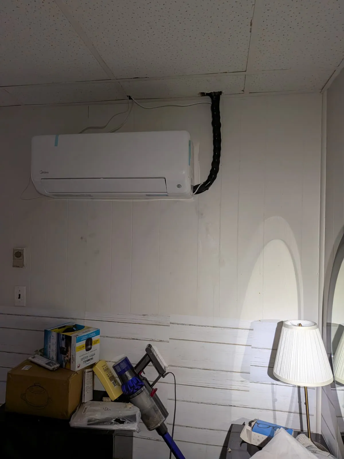 Ductless wall unit with a neat line cover in a panelled room