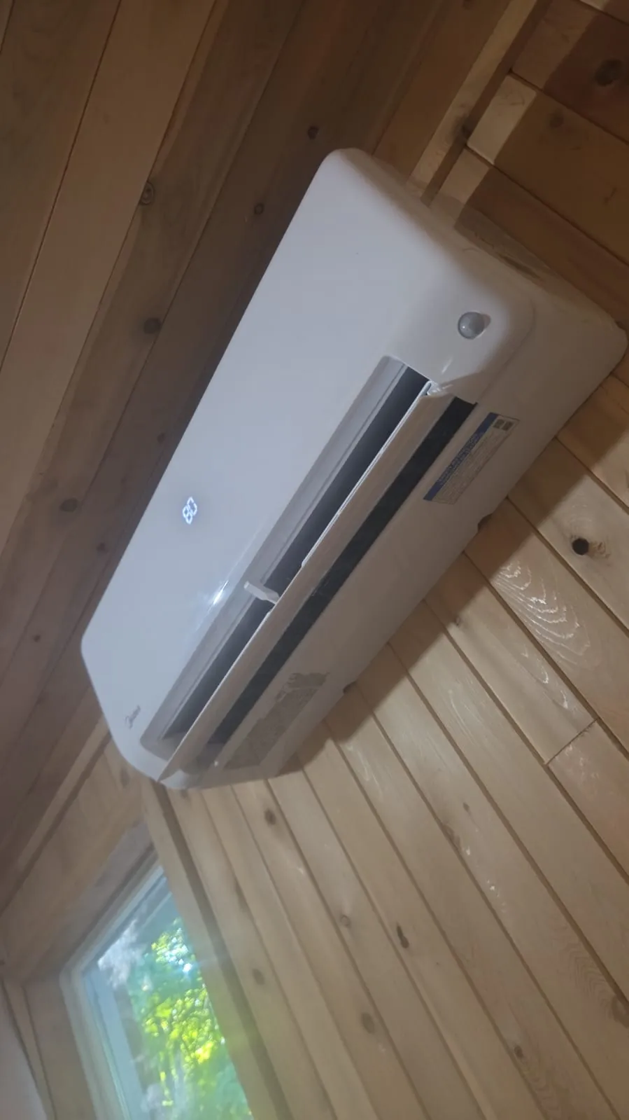 Ductless wall unit on pine panelling