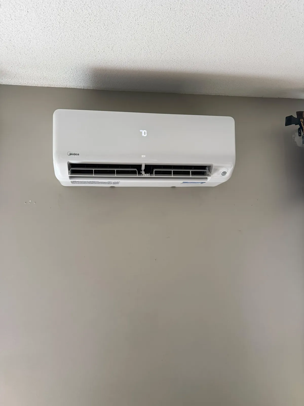 Midea ductless wall unit centred on a plain wall