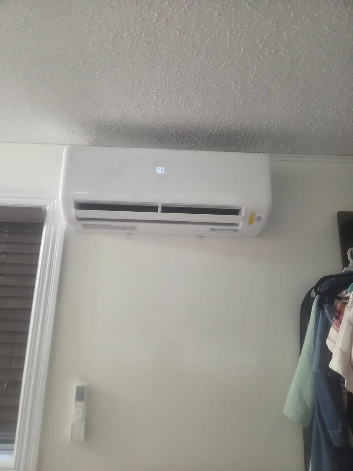 Ductless wall unit with its remote holder mounted below