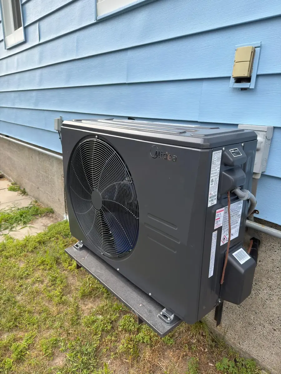 Side view of a wall-mounted Midea cold-climate heat pump