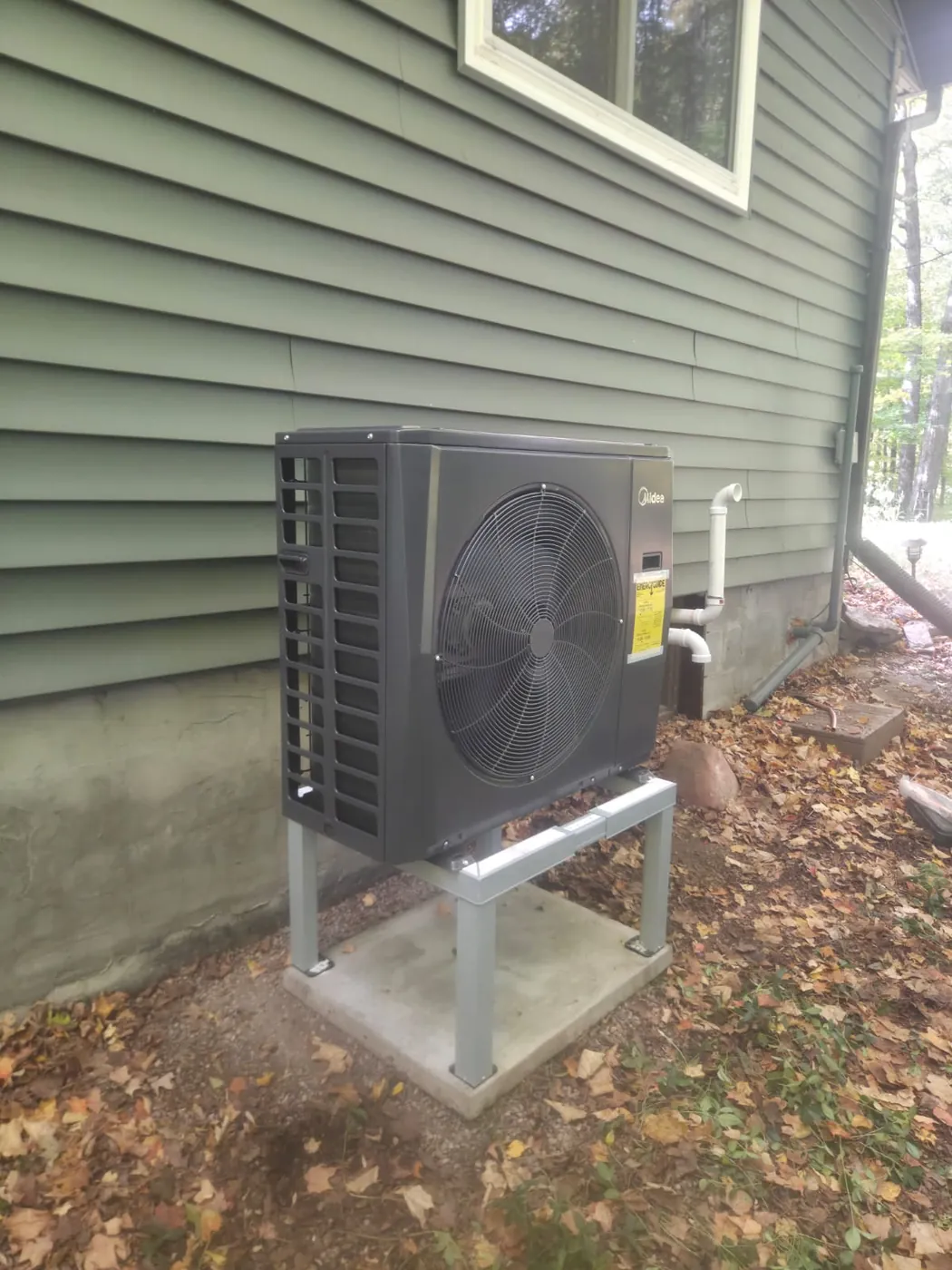Midea cold-climate heat pump on a galvanized stand