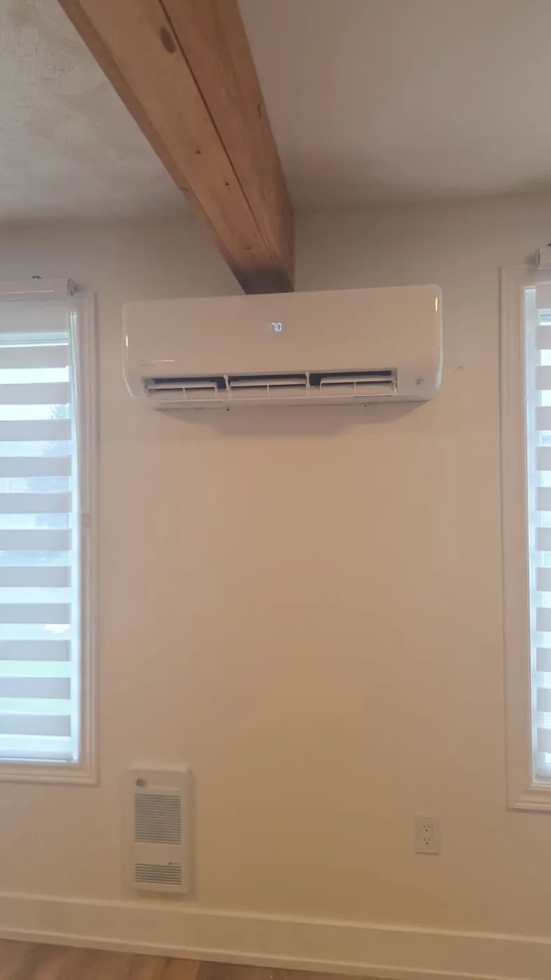 Midea ductless wall head above a window in a bright bedroom