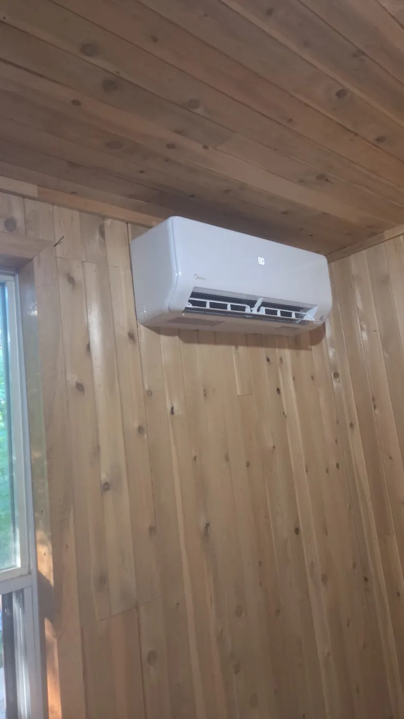 Midea ductless head in a cedar-panelled room