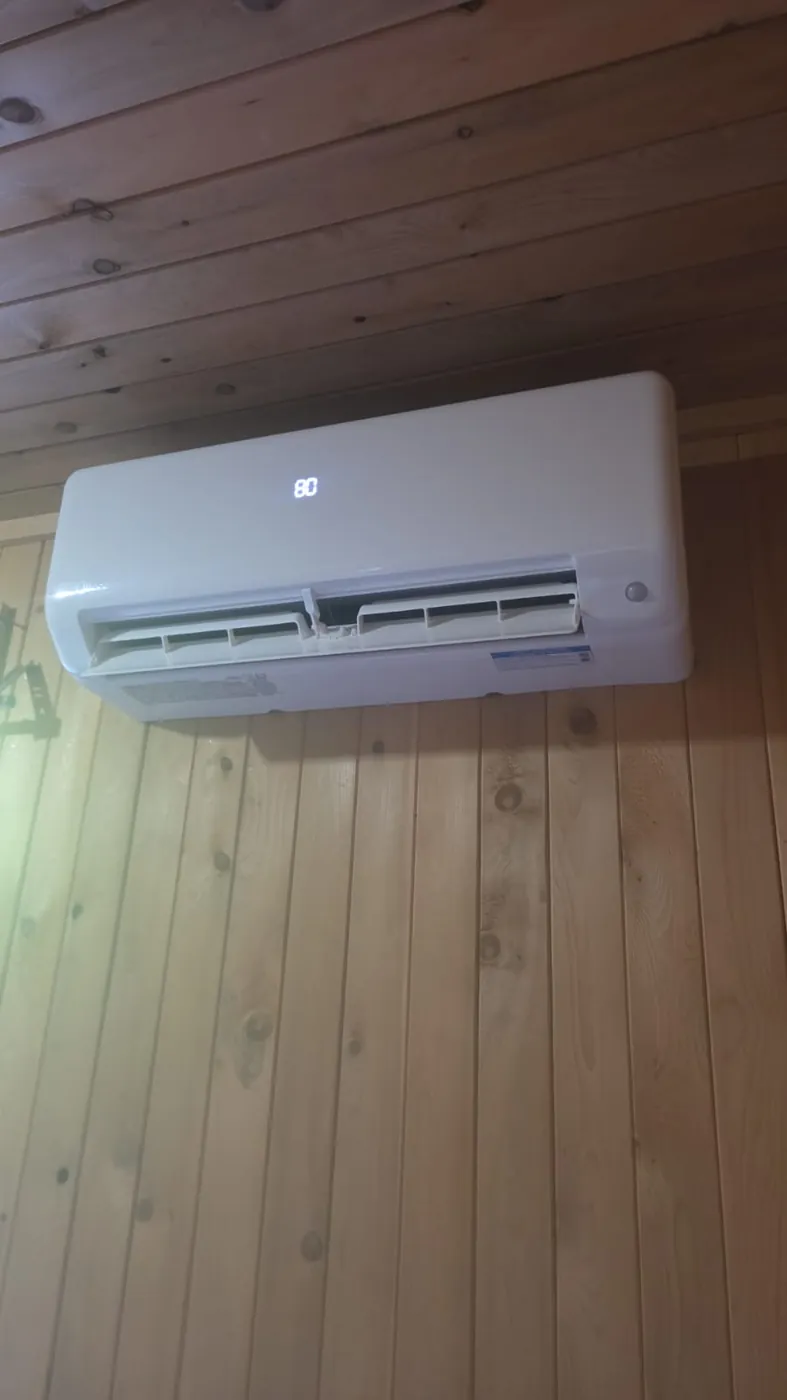 Midea ductless head on a cedar wall, front view