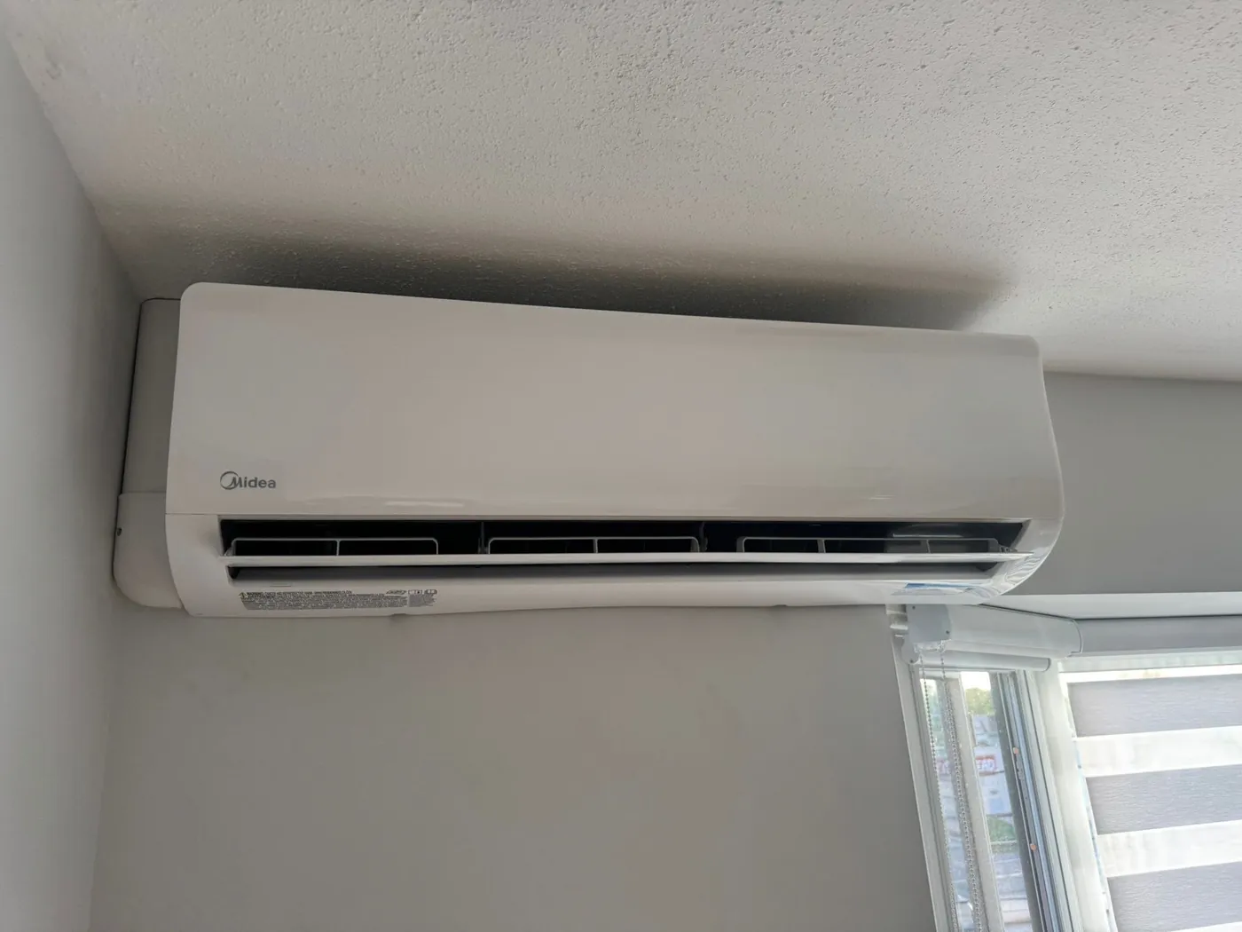 Close-up of a Midea wall-mounted ductless head