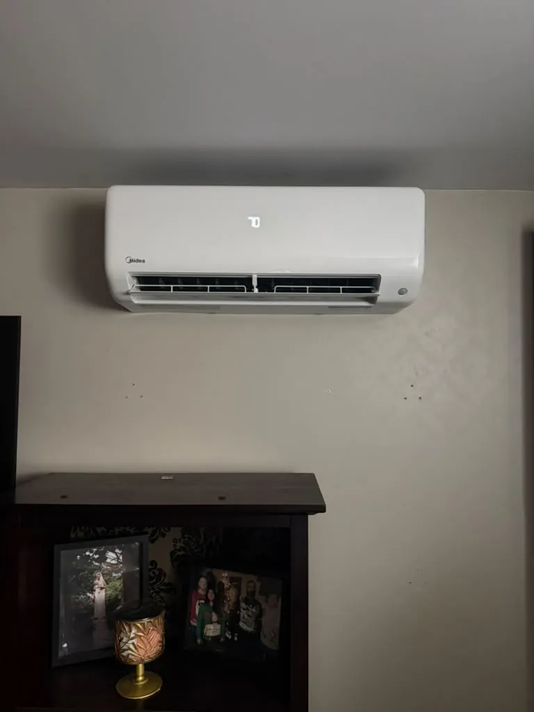 Midea ductless head above a cabinet in a family room, installed by EHI