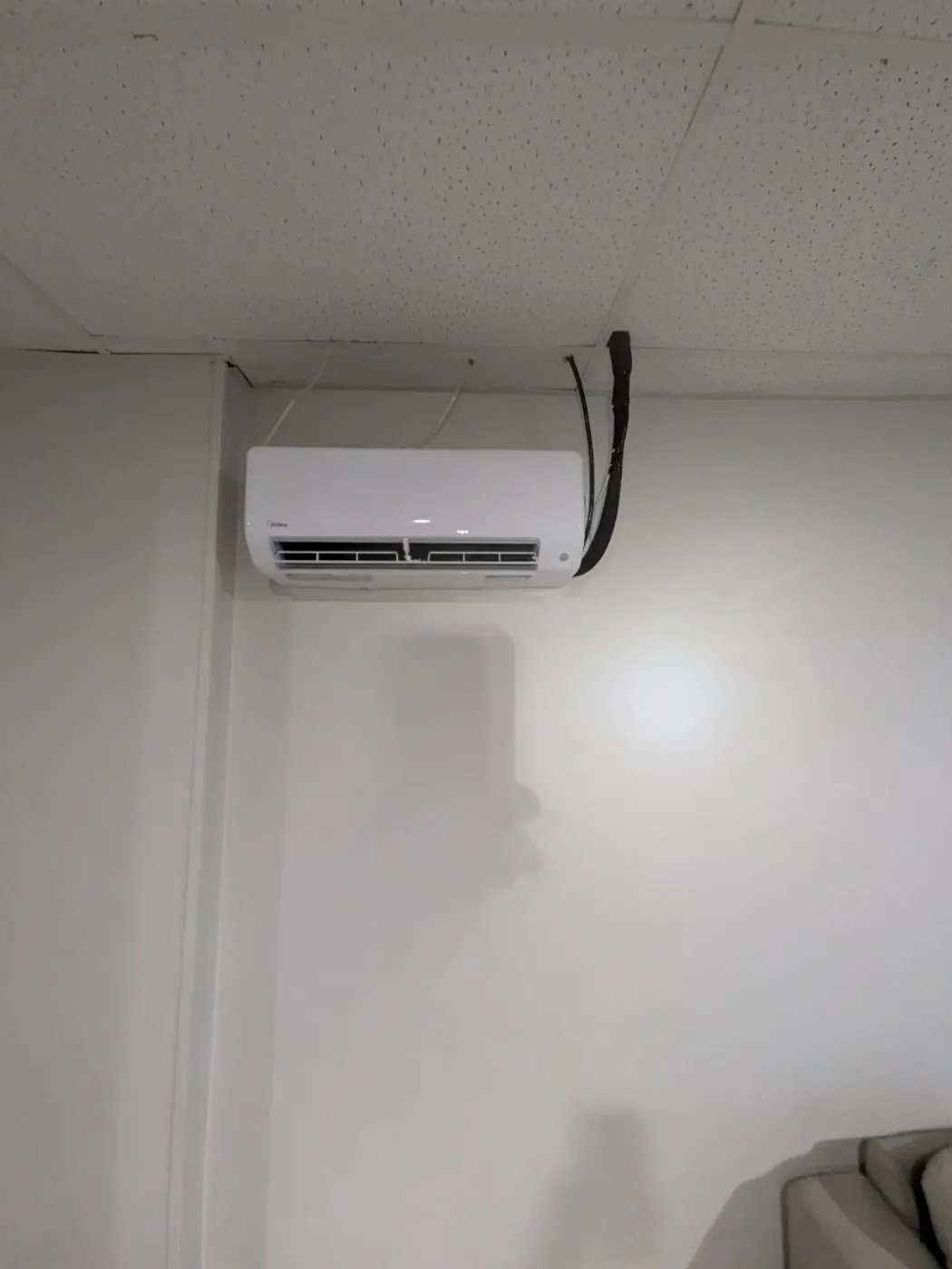 Midea ductless head on a white wall with a concealed line set